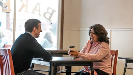 Two adults enjoying a coffee